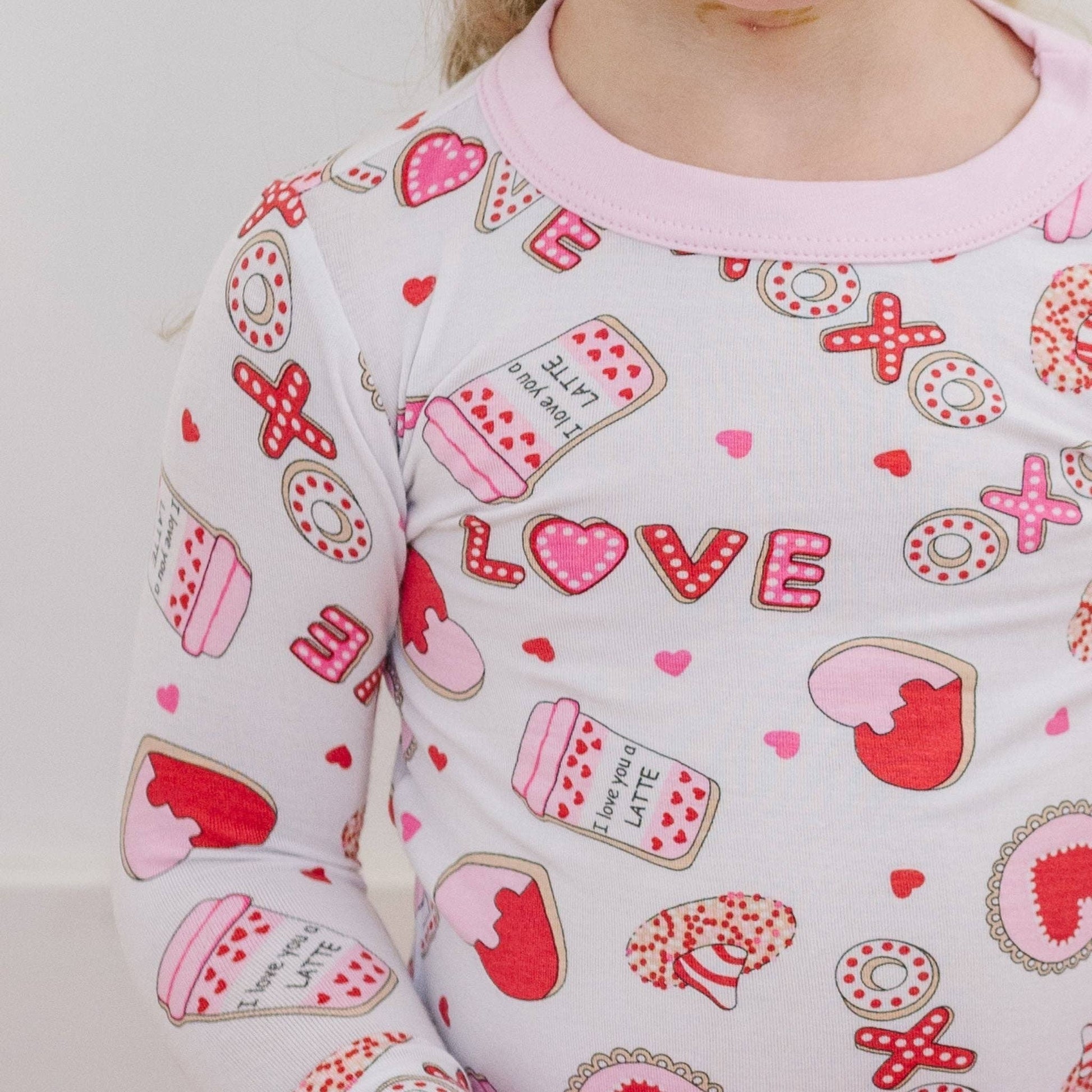 Children's pajama top with Valentine's Day-themed print on a plain background