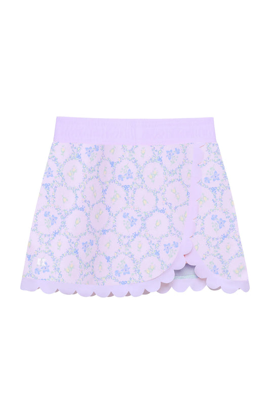 Floral patterned skirt with scalloped edge on a white background