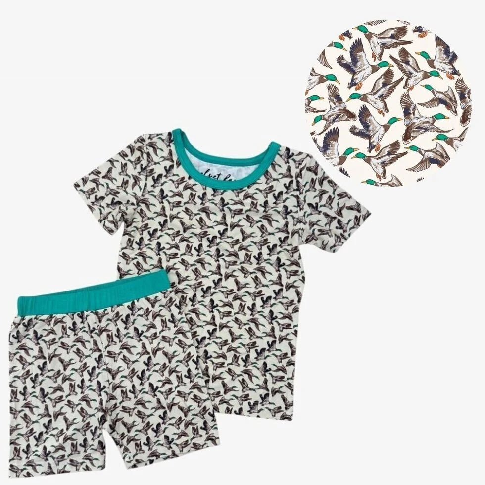 Children's pajama set with duck pattern and matching hat on a white background