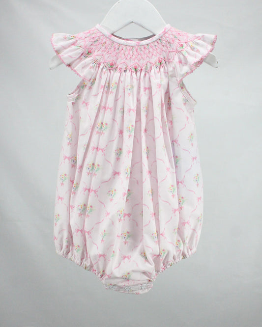 Pink floral baby romper on a gray background
