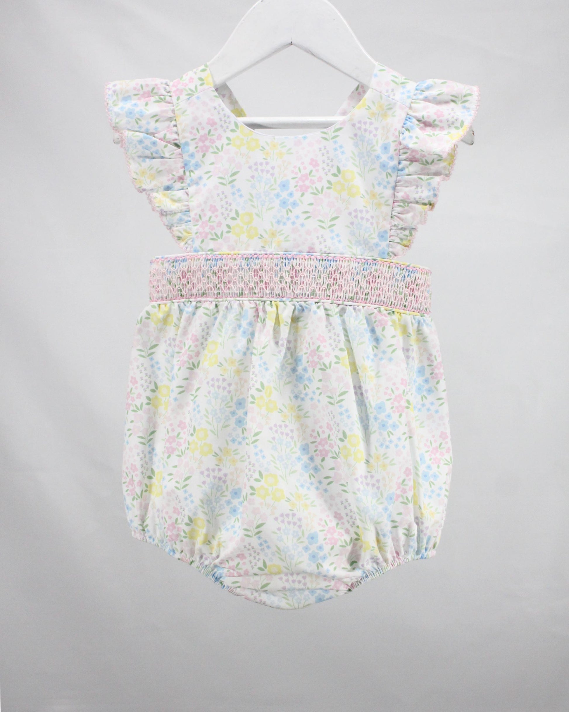 Floral baby romper on a gray background