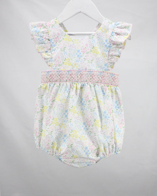 Floral baby romper on a gray background