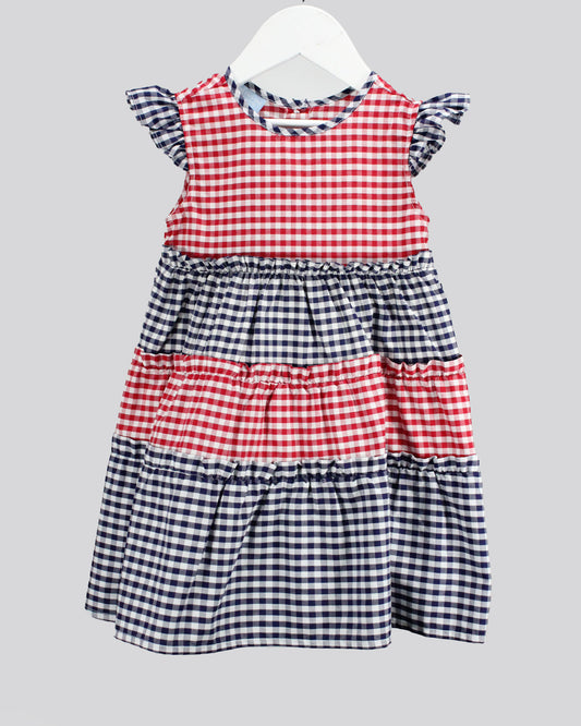 Red and blue checkered dress on a white hanger against a gray background