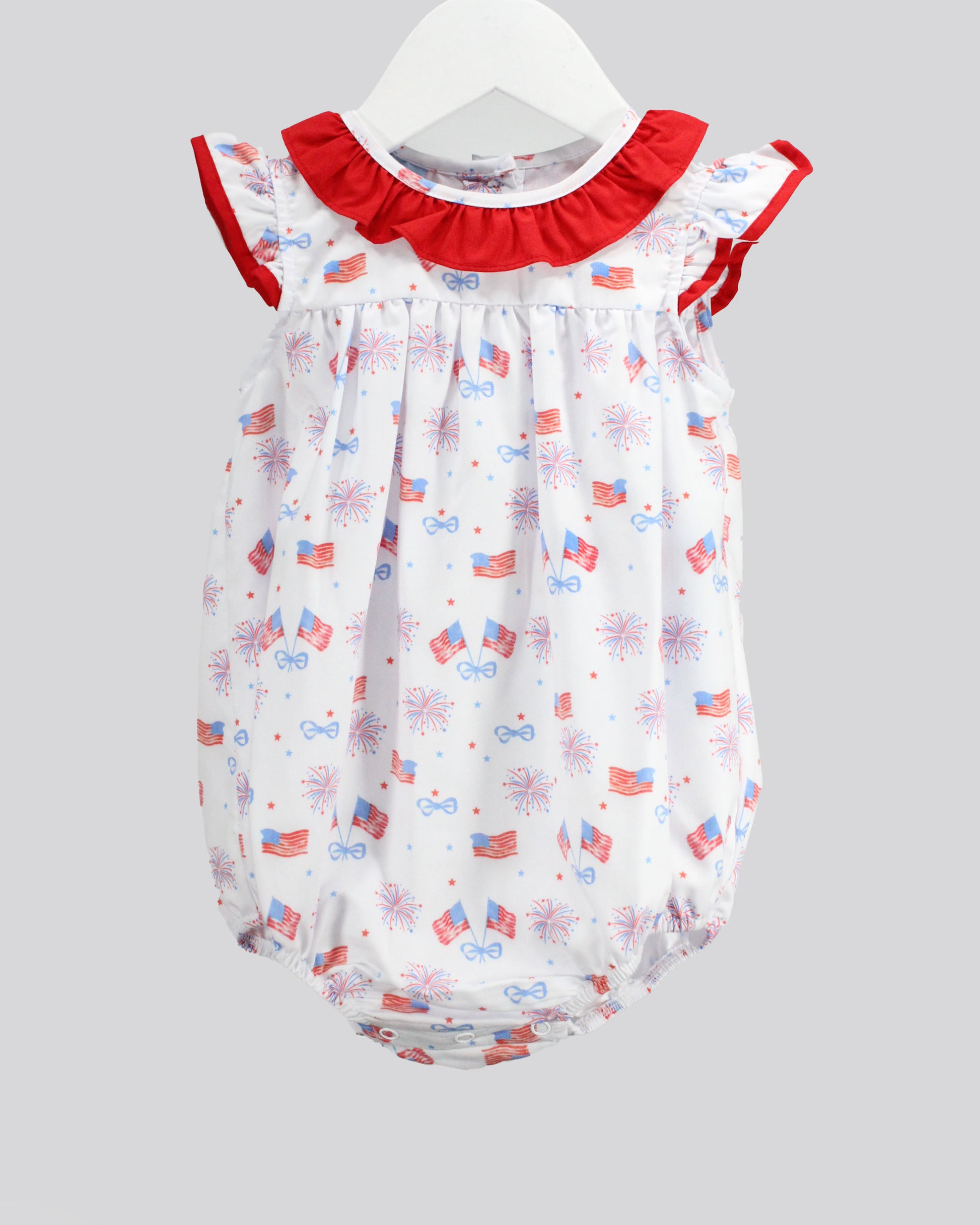 Baby romper with American flag pattern on a gray background