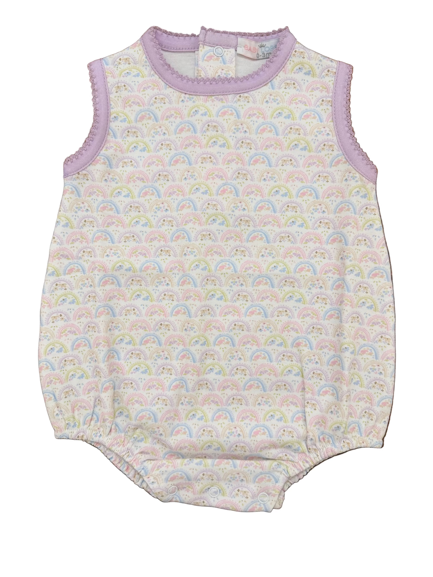 Baby romper with rainbow pattern on a wooden surface