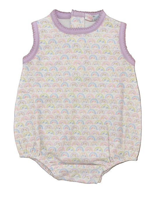 Baby romper with rainbow pattern on a wooden surface