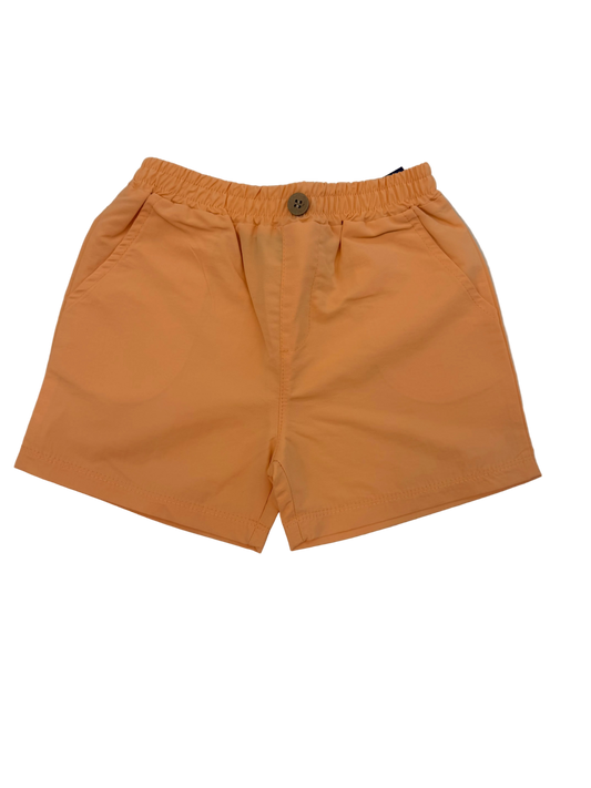 Orange shorts on a light marble floor