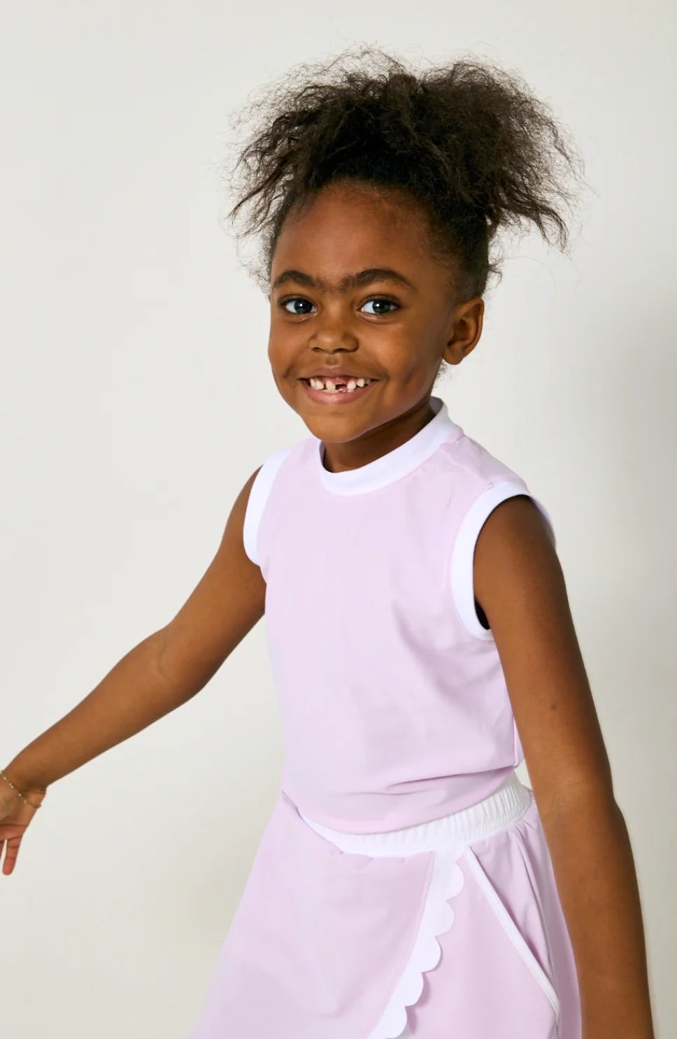 Young girl in a light purple dress against a white background