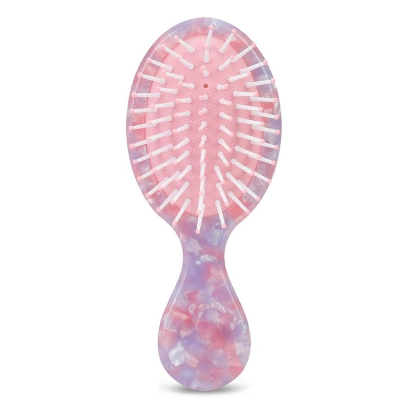 Multicolored hairbrush on a white background