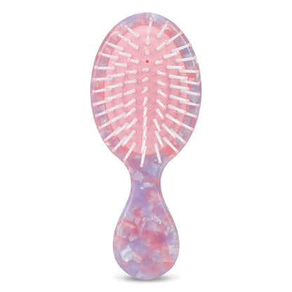 Multicolored hairbrush on a white background