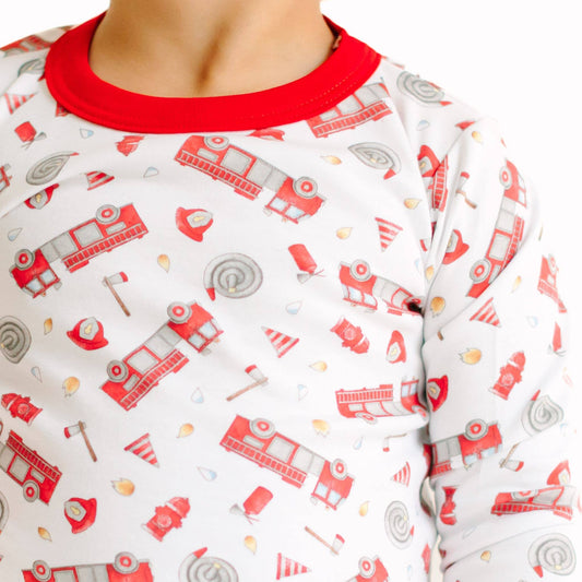 Children's pajama top with fire truck pattern on a white background