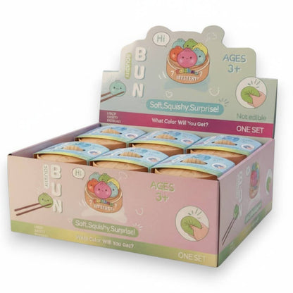 Box of soft squishy surprise toys with colorful packaging on a white background