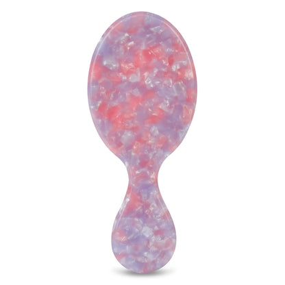 Marbled pink and purple hairbrush on a white background