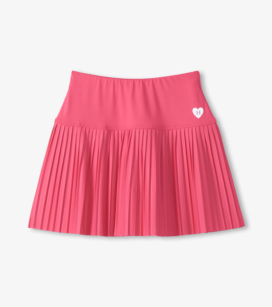 Pink pleated skirt with a heart logo on a light gray background