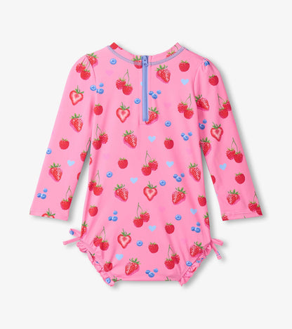 Pink children's swimsuit with strawberry pattern on a white background