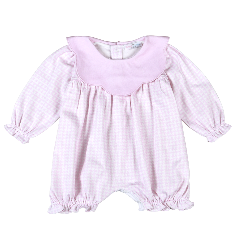 Pink baby romper with long sleeves on a white background